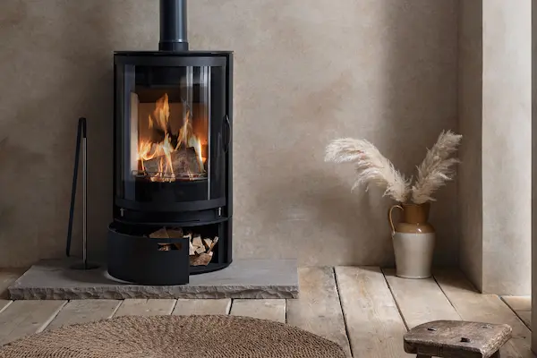 Hoxton 7kW wood burning stove shown with optional low log store